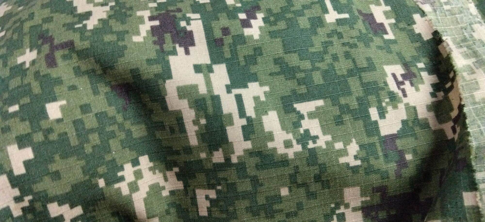 Kain army camouflage fabric with pixelated pattern in green beige and black. Suitable for military or outdoor use. Ideal for making uniforms or gear.1meter long 1meter width